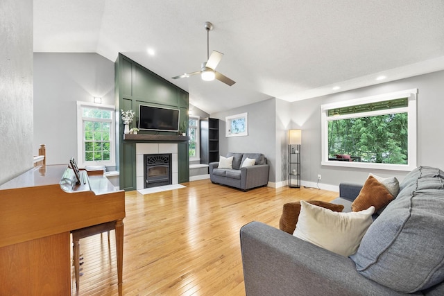 7308 W Lancaster Rd, Peoria, IL 61607 - living area featuring vaulted ceiling, ceiling fan, light wood-style flooring, a fireplace, and recessed lighting
