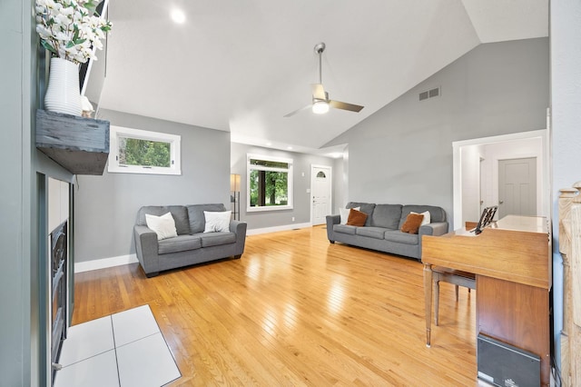 7308 W Lancaster Rd, Peoria, IL 61607 - living room featuring wood finished floors, a ceiling fan, baseboards, and high vaulted ceiling