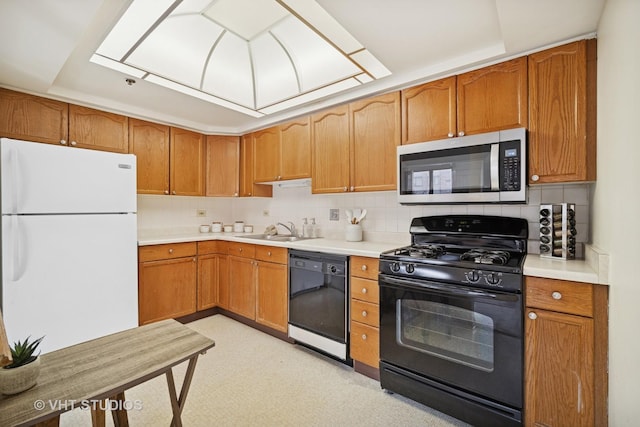 1653 River St Unit 405, Des Plaines, IL 60016 - kitchen with black appliances, a sink, light countertops, and tasteful backsplash