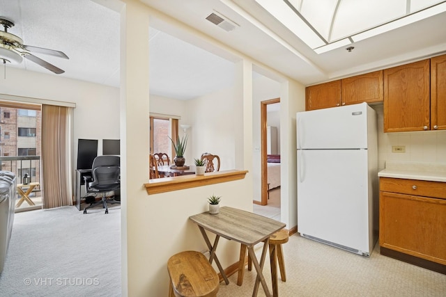1653 River St Unit 405, Des Plaines, IL 60016 - kitchen with freestanding refrigerator, plenty of natural light, a desk, and brown cabinetry