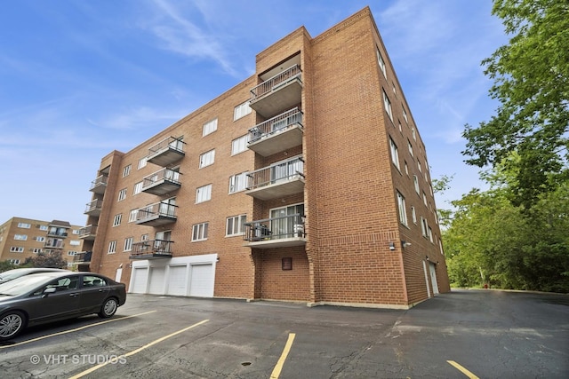 1653 River St Unit 405, Des Plaines, IL 60016 - view of apartment building / complex featuring uncovered parking
