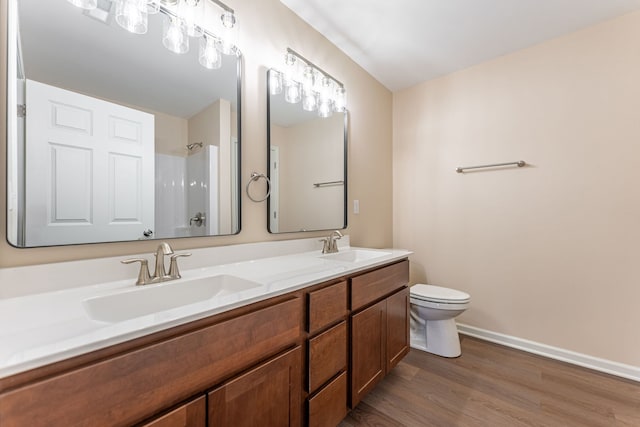 896 Fuller Ln, Belvidere, IL 61008 - full bath featuring double vanity, toilet, wood finished floors, baseboards, and a shower