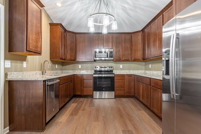 896 Fuller Ln, Belvidere, IL 61008 - kitchen featuring appliances with stainless steel finishes, a sink, light wood-type flooring, a chandelier, and light stone counters