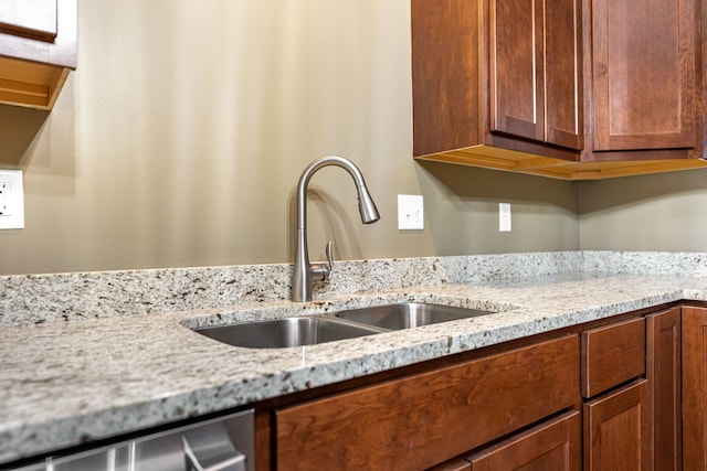 896 Fuller Ln, Belvidere, IL 61008 - kitchen with a sink, light stone countertops, brown cabinets, and stainless steel dishwasher