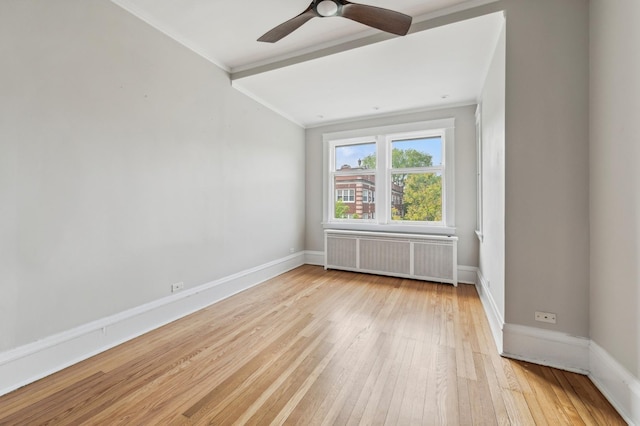 502 Lee St Unit 3, Evanston, IL 60202 - spare room with radiator heating unit, crown molding, light wood-type flooring, a ceiling fan, and baseboards