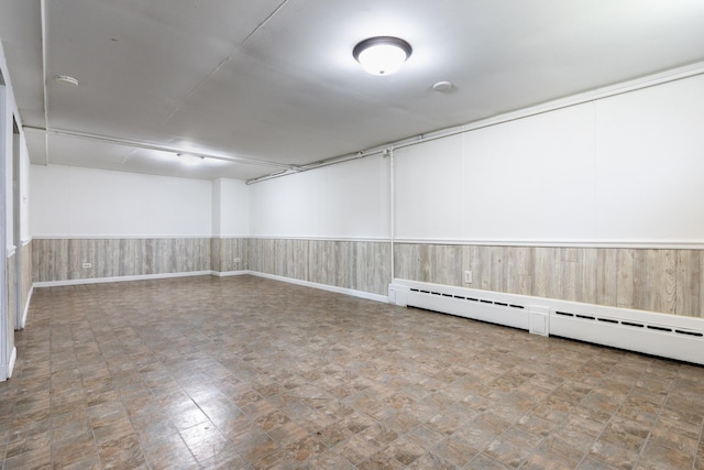 814 S Harvard Ave, Villa Park, IL 60181 - unfurnished room featuring a baseboard heating unit, wainscoting, wood walls, and tile patterned floors