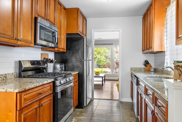 814 S Harvard Ave, Villa Park, IL 60181 - kitchen with appliances with stainless steel finishes, decorative backsplash, baseboard heating, light stone counters, and tile patterned flooring