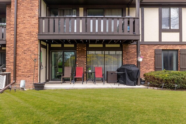11212 Cottonwood Dr Unit 23A, Palos Hills, IL 60465 - rear view of house featuring a balcony, a yard, and brick siding