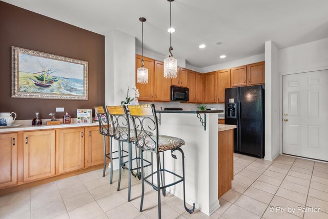 5611 Wildspring Dr, Lake In The Hills, IL 60156 - kitchen featuring black appliances, a breakfast bar, light tile patterned floors, recessed lighting, and hanging light fixtures