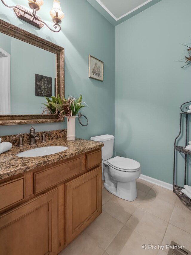 5611 Wildspring Dr, Lake In The Hills, IL 60156 - half bathroom with vanity, tile patterned flooring, toilet, baseboards, and a chandelier