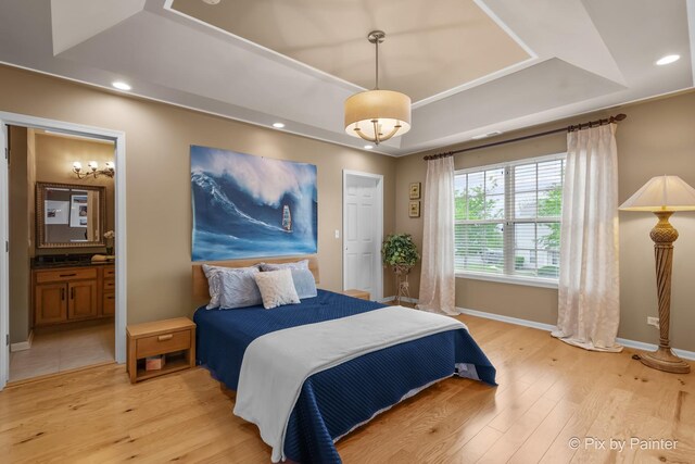 5611 Wildspring Dr, Lake In The Hills, IL 60156 - bedroom with a raised ceiling, light wood-style floors, baseboards, recessed lighting, and ensuite bath