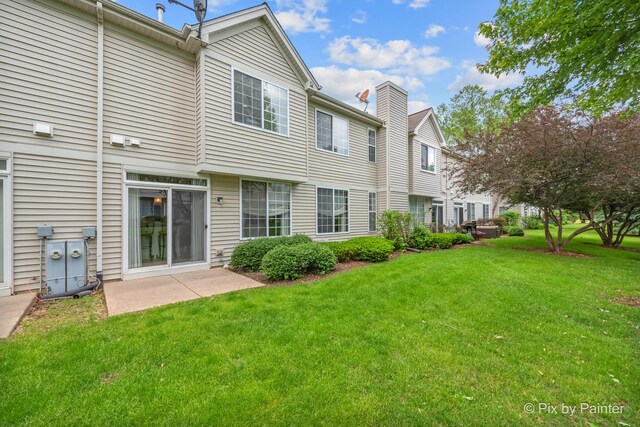 5611 Wildspring Dr, Lake In The Hills, IL 60156 - rear view of house featuring a yard and a chimney