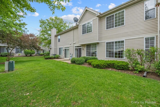 5611 Wildspring Dr, Lake In The Hills, IL 60156 - back of house with a lawn and a chimney