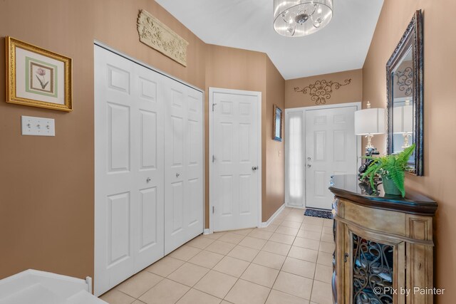 5611 Wildspring Dr, Lake In The Hills, IL 60156 - foyer entrance featuring a chandelier, light tile patterned flooring, and baseboards
