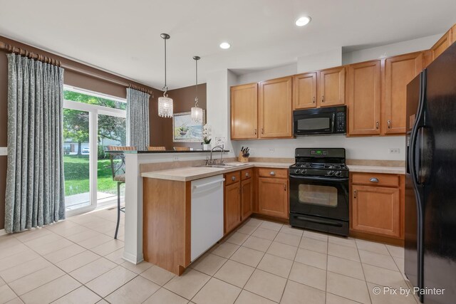 5611 Wildspring Dr, Lake In The Hills, IL 60156 - kitchen with black appliances, a sink, a peninsula, decorative light fixtures, and light tile patterned flooring