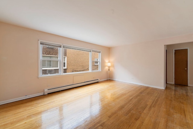 6248 W Montrose Ave Unit 1R, Chicago, IL 60634 - empty room featuring a baseboard heating unit, wood finished floors, and baseboards
