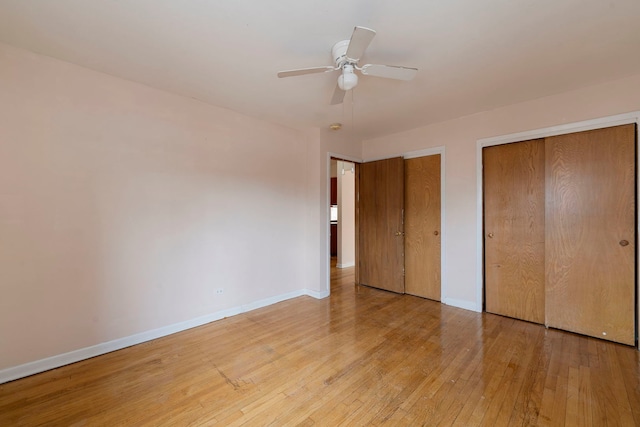 6248 W Montrose Ave Unit 1R, Chicago, IL 60634 - unfurnished bedroom featuring wood-type flooring, two closets, and baseboards