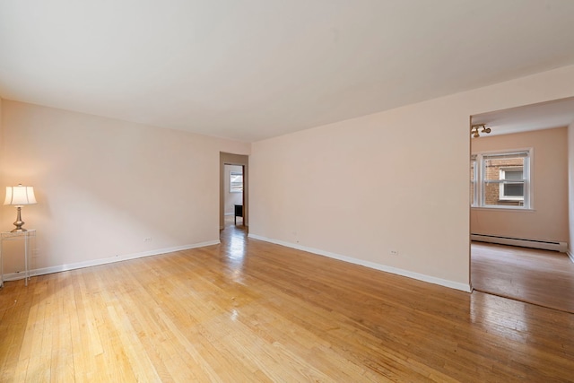 6248 W Montrose Ave Unit 1R, Chicago, IL 60634 - unfurnished room with light wood finished floors, a baseboard radiator, and baseboards