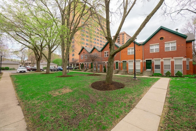 1537 N Clybourn Ave Unit D, Chicago, IL 60610 - view of front of house with brick siding, a front lawn, and entry steps