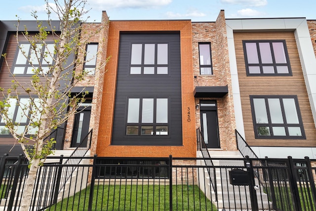 3450 N Central Ave, Chicago, IL 60634 - view of front of property with a fenced front yard and brick siding