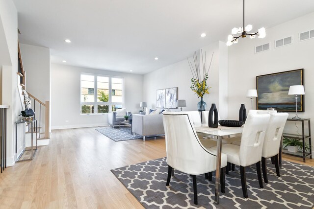 3450 N Central Ave, Chicago, IL 60634 - dining area with a chandelier, wood finished floors, stairway, recessed lighting, and baseboards