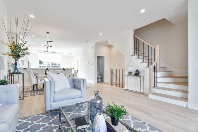 3450 N Central Ave, Chicago, IL 60634 - living room with light wood-style flooring, recessed lighting, baseboards, stairway, and a chandelier