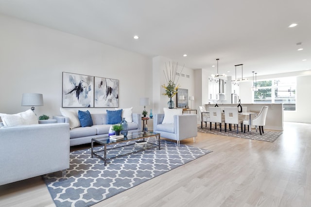 3450 N Central Ave, Chicago, IL 60634 - living area with light wood-type flooring, recessed lighting, baseboards, and a chandelier