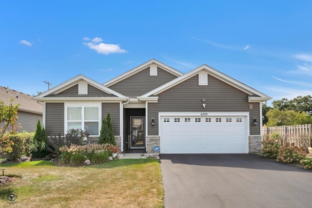 6359 Doral Dr, Gurnee, IL 60031 - ranch-style home with asphalt driveway, stone siding, and a garage
