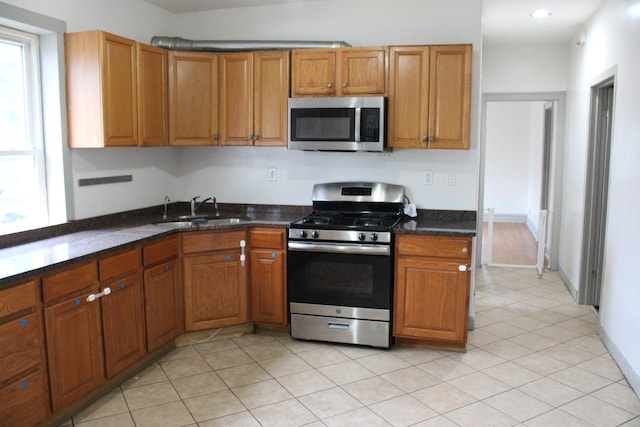 2102 Gunderson Ave, Berwyn, IL 60402 - kitchen with stainless steel appliances, brown cabinets, light tile patterned flooring, dark stone counters, and recessed lighting