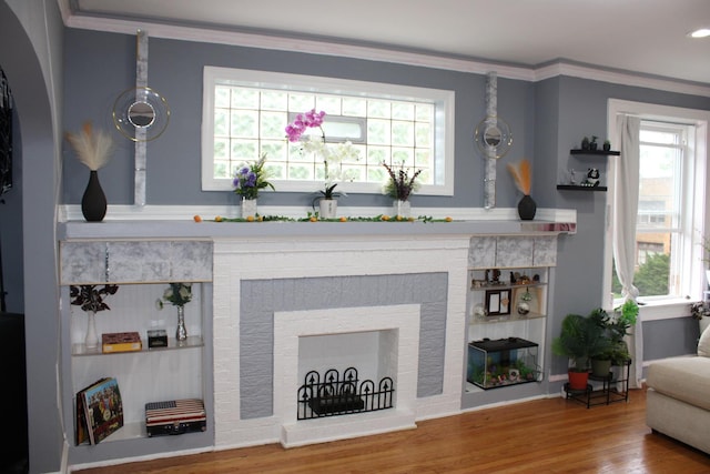 2102 Gunderson Ave, Berwyn, IL 60402 - living room with healthy amount of natural light, wood finished floors, ornamental molding, and a brick fireplace