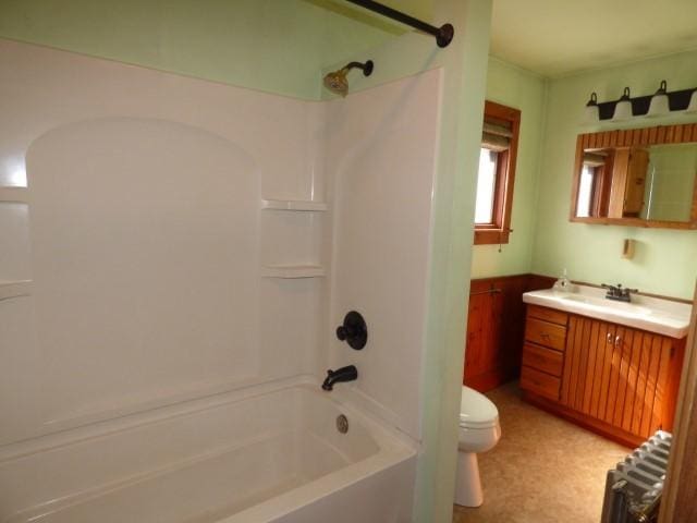 516 Spring St, Galena, IL 61036 - full bath with radiator heating unit, vanity, toilet, tub / shower combination, and wainscoting