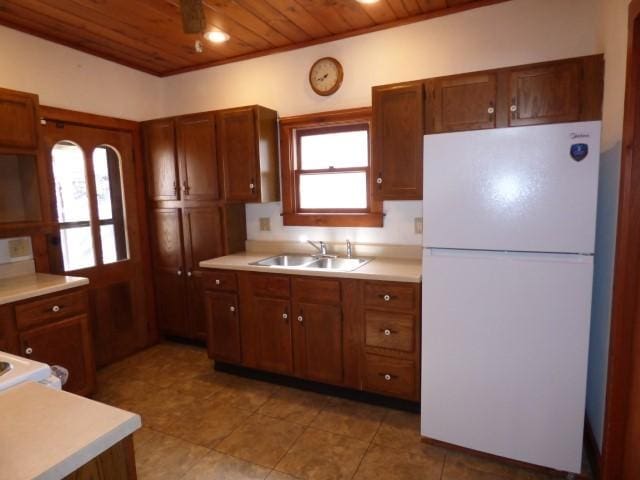 516 Spring St, Galena, IL 61036 - kitchen featuring freestanding refrigerator, wood ceiling, a sink, light countertops, and light tile patterned floors