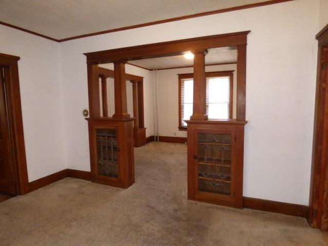 516 Spring St, Galena, IL 61036 - carpeted empty room featuring baseboards and crown molding