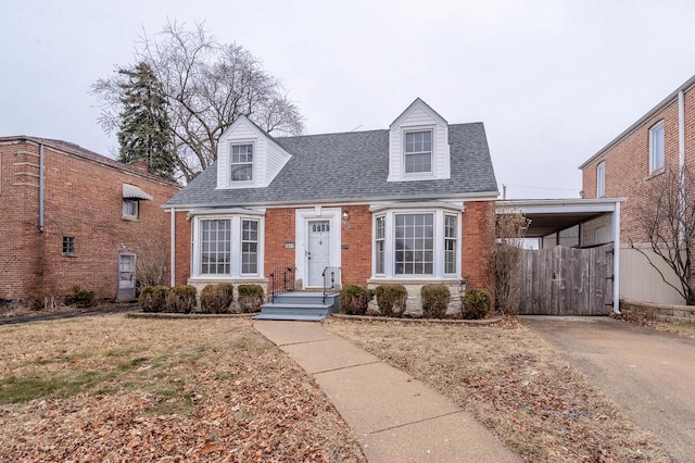 5651 N Osceola Ave, Chicago, IL 60631 - cape cod home featuring a shingled roof, asphalt driveway, an attached carport, and brick siding