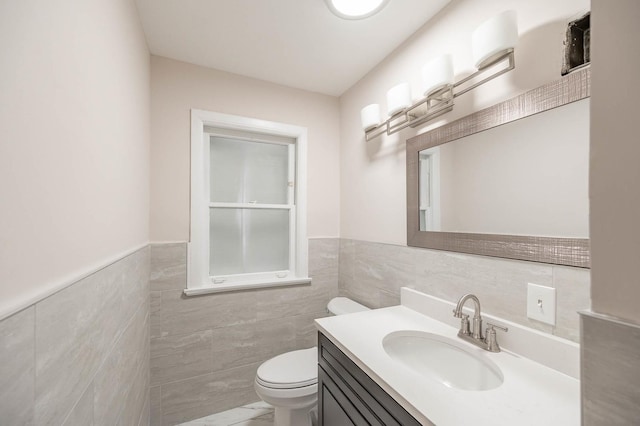 5651 N Osceola Ave, Chicago, IL 60631 - bathroom with tile walls, toilet, vanity, and wainscoting