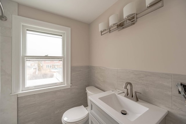 5651 N Osceola Ave, Chicago, IL 60631 - half bathroom with tile walls, toilet, vanity, and wainscoting
