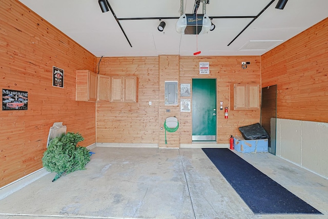 3503 Blue Ridge Ct, Carpentersville, IL 60110 - garage featuring a garage door opener, wood walls, and electric panel