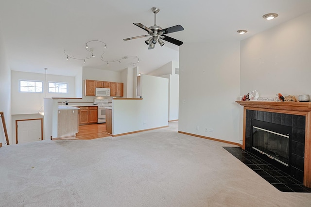 3503 Blue Ridge Ct, Carpentersville, IL 60110 - unfurnished living room with light colored carpet, a tile fireplace, ceiling fan, and lofted ceiling