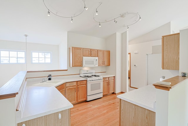 3503 Blue Ridge Ct, Carpentersville, IL 60110 - kitchen featuring white appliances, lofted ceiling, light wood-type flooring, a peninsula, and light countertops