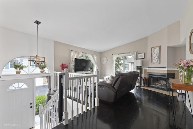 7612 W Saint Francis Rd Unit 7612, Frankfort, IL 60423 - living room featuring a tile fireplace, a chandelier, wood finished floors, and lofted ceiling