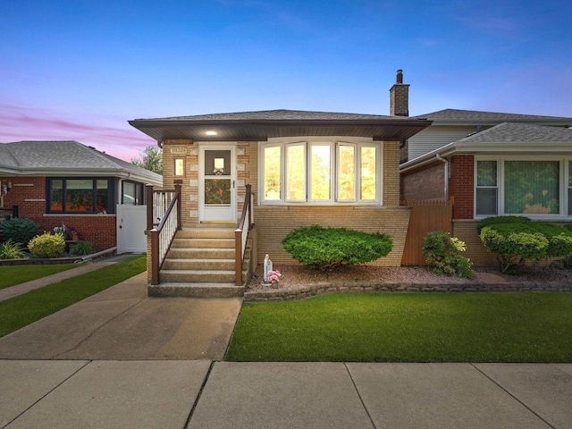 10324 S Sacramento Ave, Chicago, IL 60655 - view of front of house featuring brick siding, a chimney, and a front yard