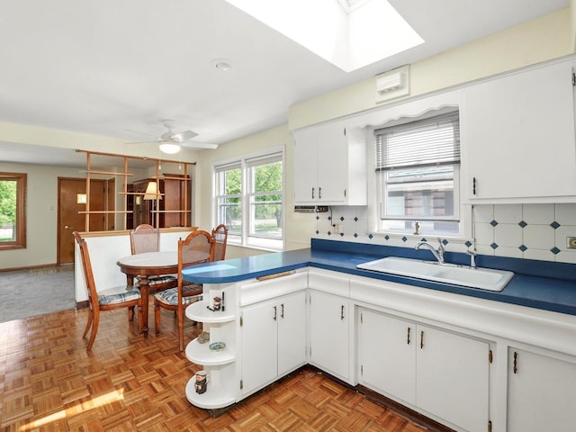 10324 S Sacramento Ave, Chicago, IL 60655 - kitchen featuring open shelves, a skylight, white cabinetry, backsplash, and a ceiling fan