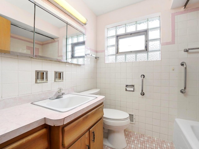 10324 S Sacramento Ave, Chicago, IL 60655 - bathroom with tile walls, tile patterned flooring, a tub, vanity, and a wainscoted wall