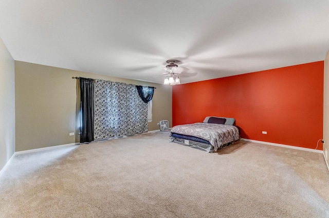 1715 Ivy Ln, Montgomery, IL 60538 - unfurnished bedroom featuring carpet floors, baseboards, and a ceiling fan