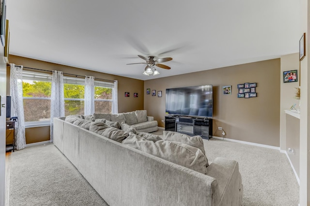 1715 Ivy Ln, Montgomery, IL 60538 - living room featuring a ceiling fan, carpet floors, and baseboards