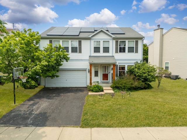 1715 Ivy Ln, Montgomery, IL 60538 - view of front of home featuring an attached garage, a front lawn, asphalt driveway, central AC, and roof mounted solar panels