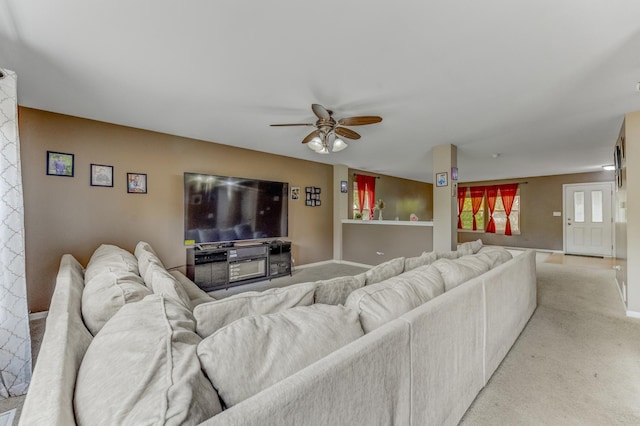 1715 Ivy Ln, Montgomery, IL 60538 - living area with light carpet, ceiling fan, and baseboards