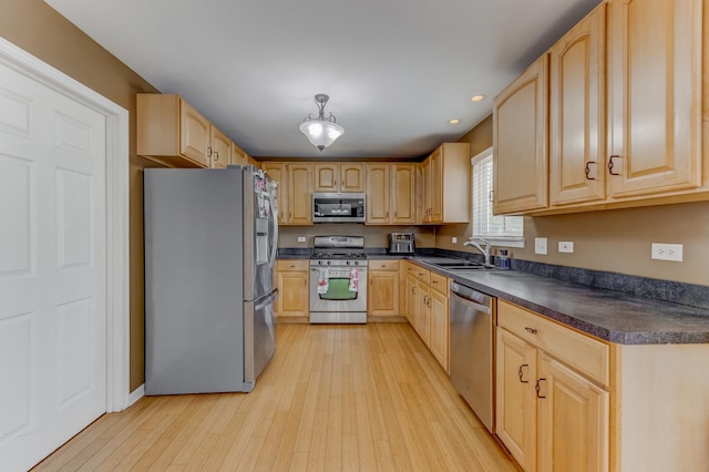 1715 Ivy Ln, Montgomery, IL 60538 - kitchen with stainless steel appliances, a sink, light brown cabinets, dark countertops, and recessed lighting