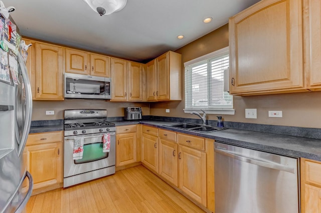 1715 Ivy Ln, Montgomery, IL 60538 - kitchen featuring appliances with stainless steel finishes, a sink, dark countertops, and recessed lighting