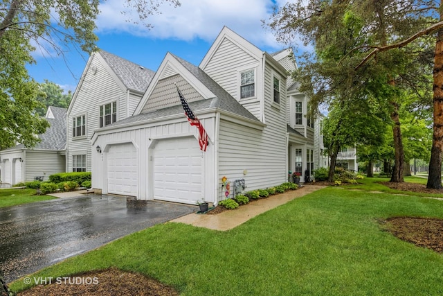 400 Hill Ct Unit 0, Wauconda, IL 60084 - view of front of house with roof with shingles, asphalt driveway, a garage, a front lawn, and board and batten siding
